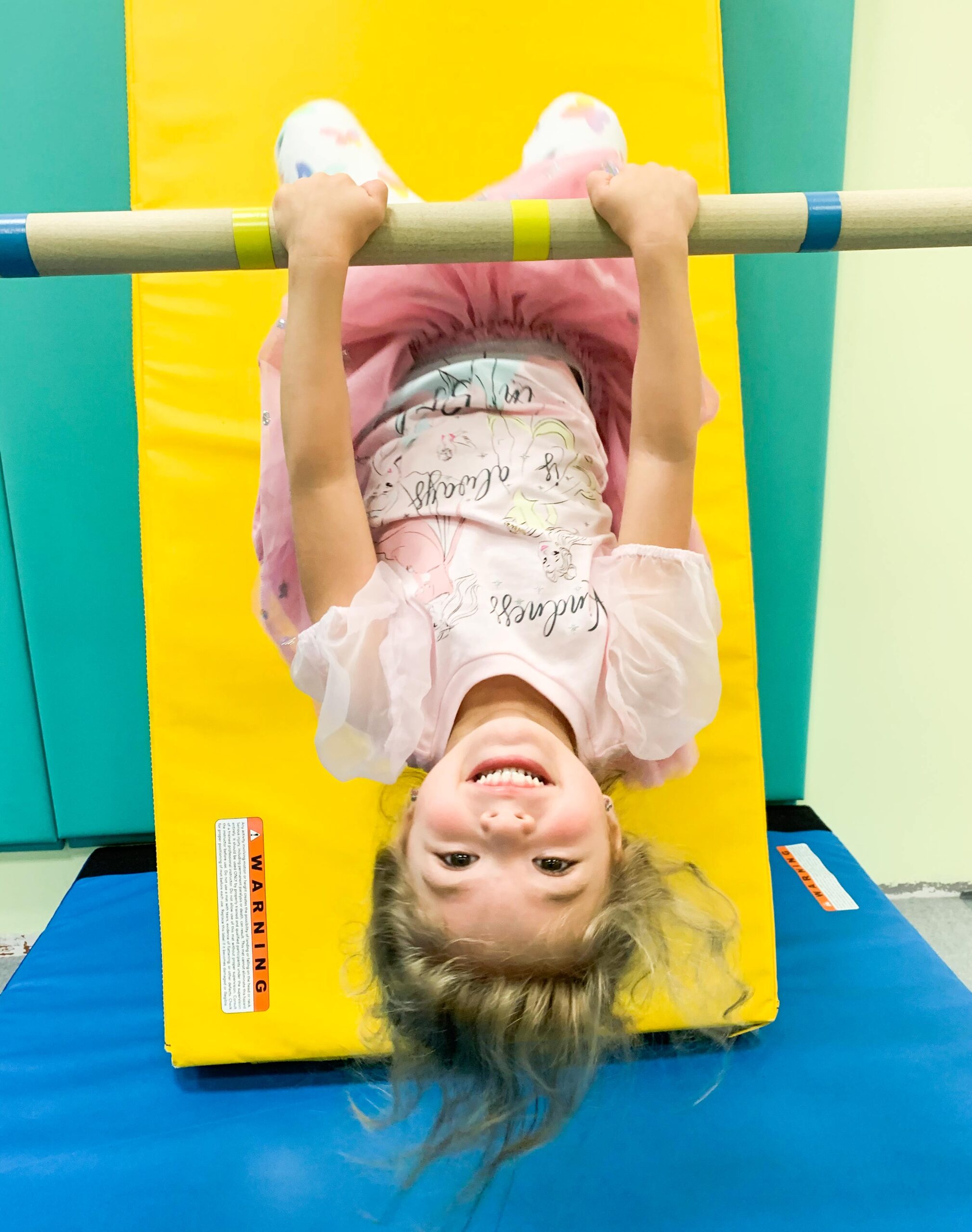 A little girl having fun in her gymnastics classes in Austin, TX